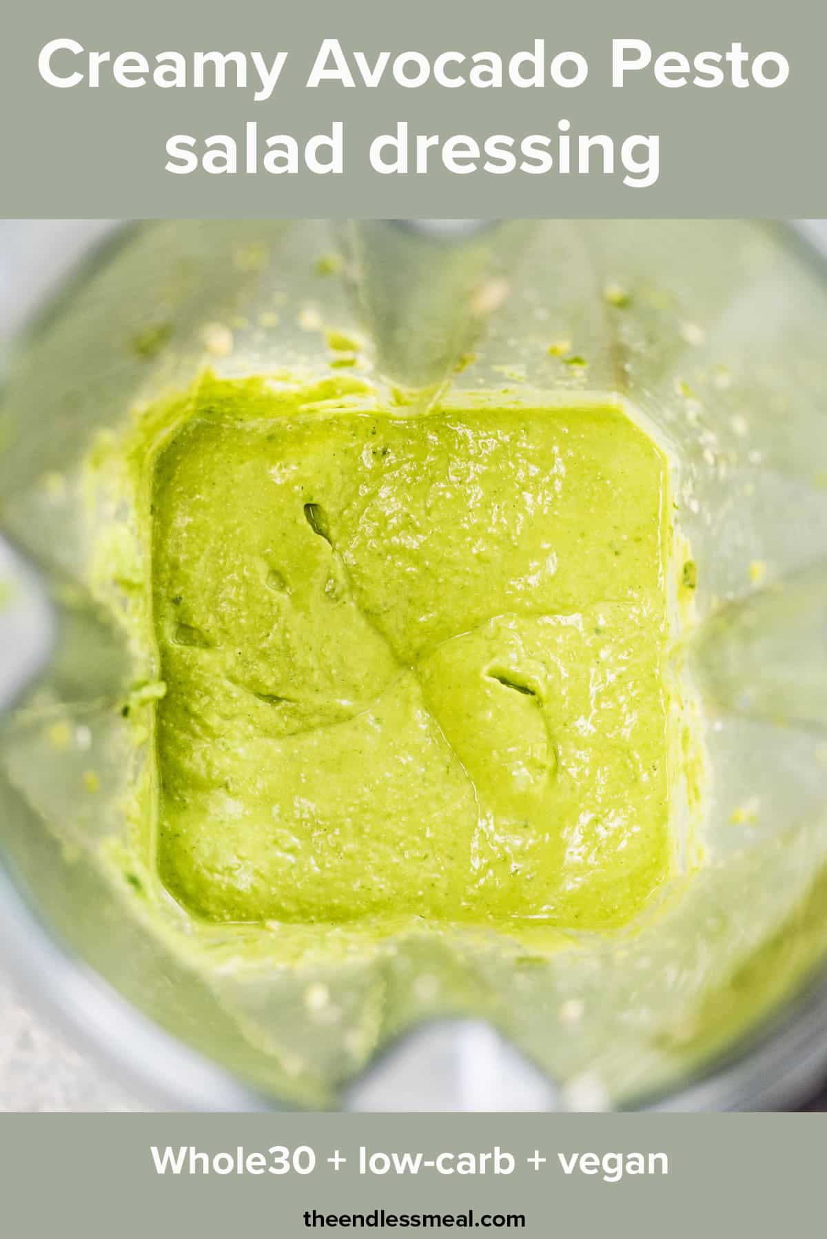 Avocado pesto salad dressing in a blender with the recipe title on top of the picture. 