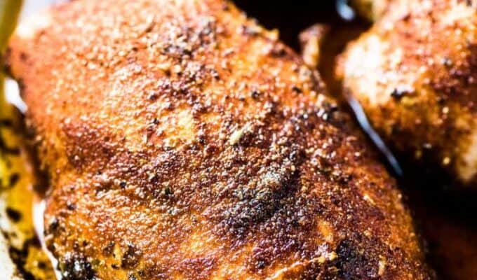 A close up of perfect baked chicken breasts in a pan.