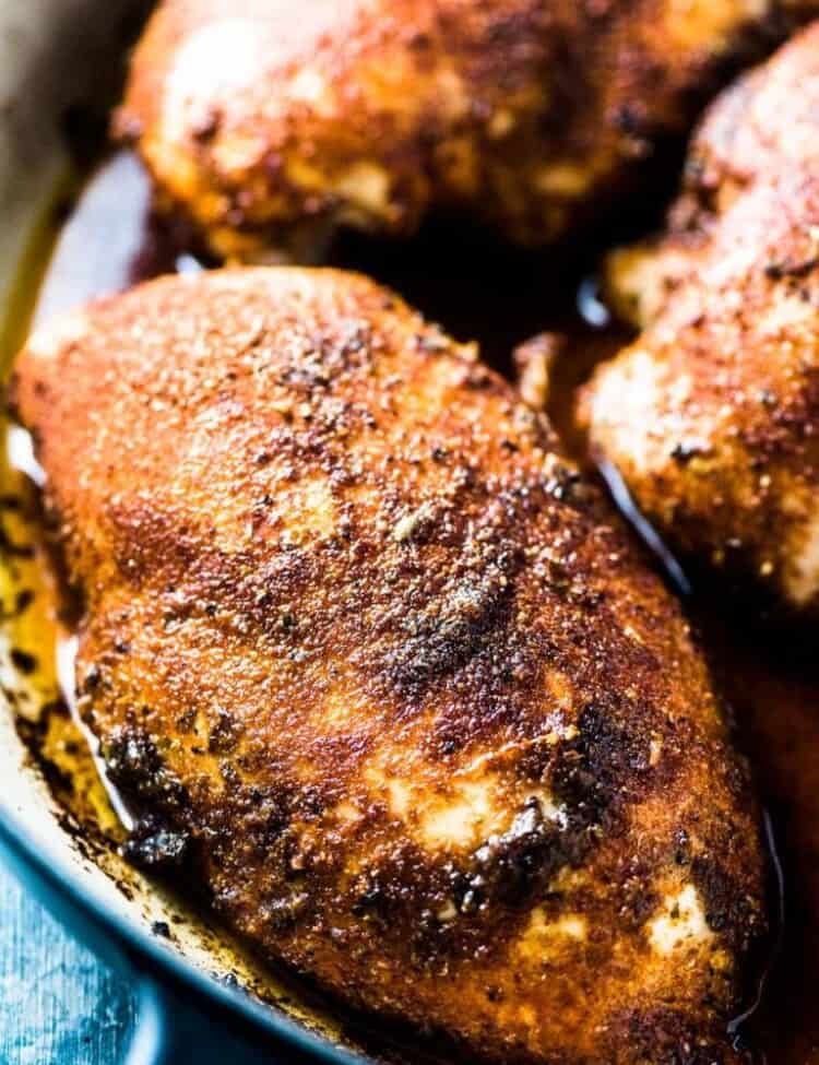 A close up of perfect baked chicken breasts in a pan.