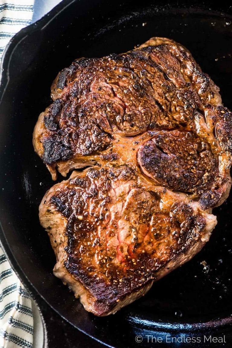 A perfectly seared prime rib steak in a pan. Steak salad is on it's way!