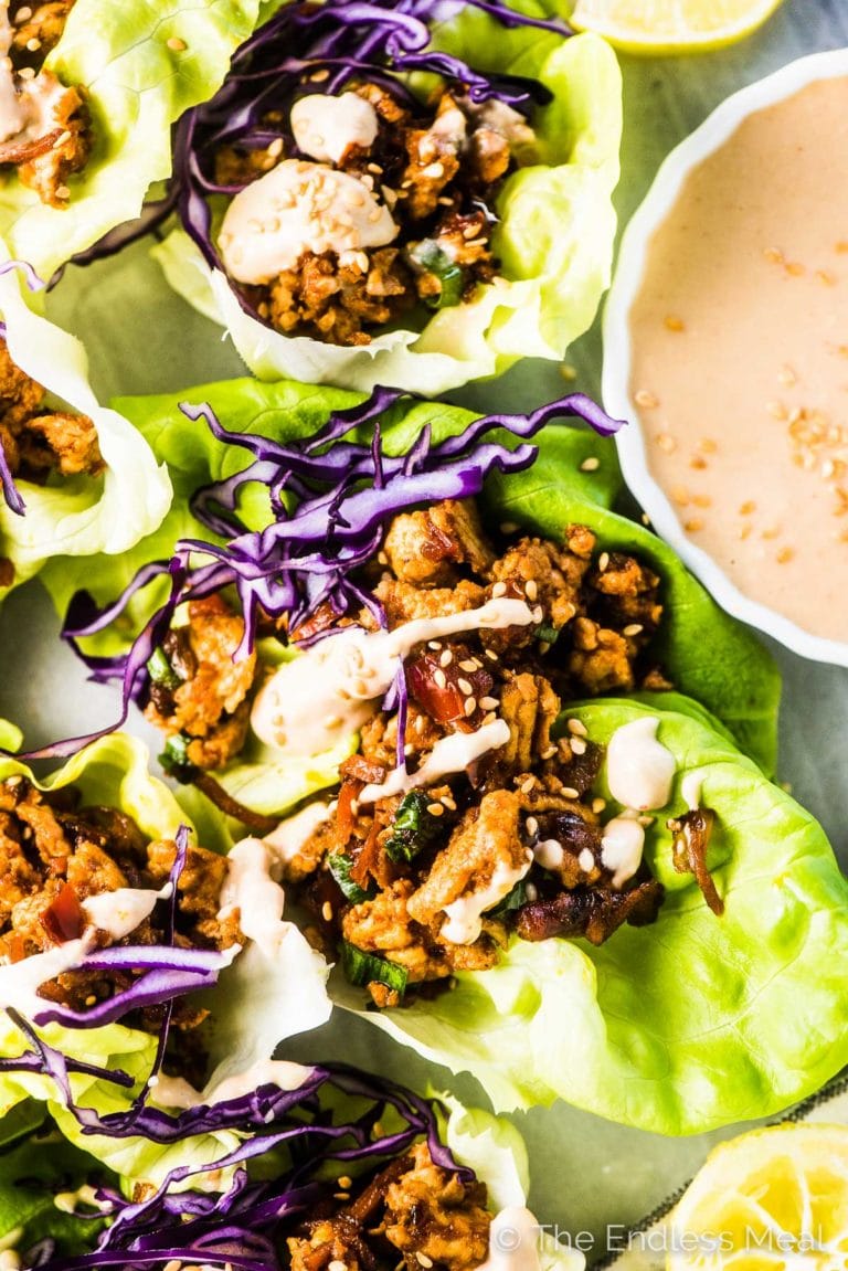 A close up of these Thai turkey lettuce wraps with tahini sauce drizzled over the top. 