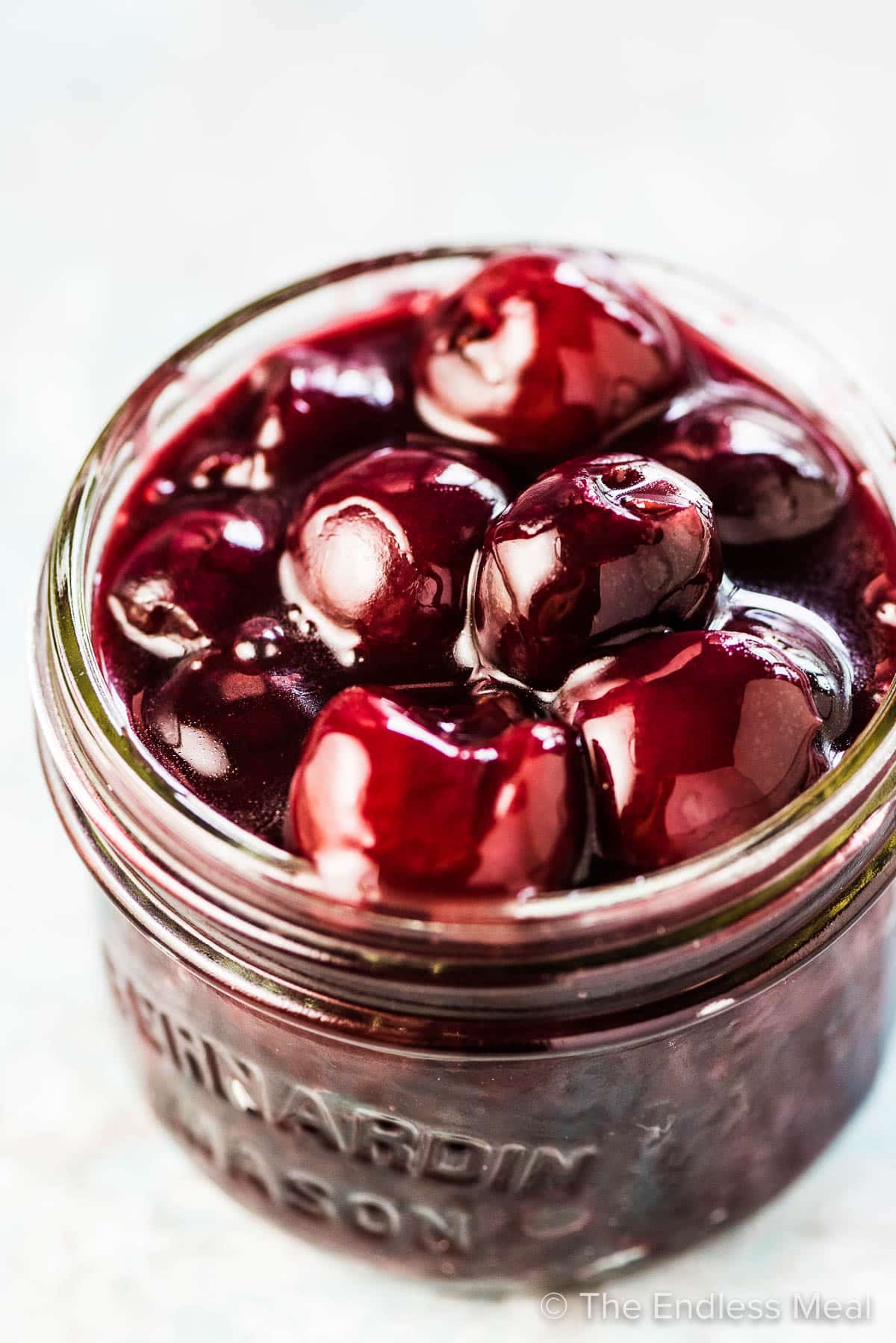 Cherry sauce in a glass jar.