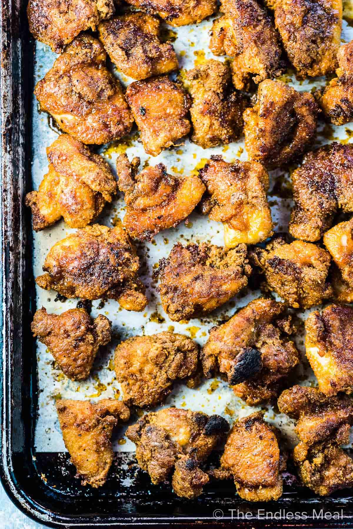 A baking tray filled with crispy easy chicken bites.