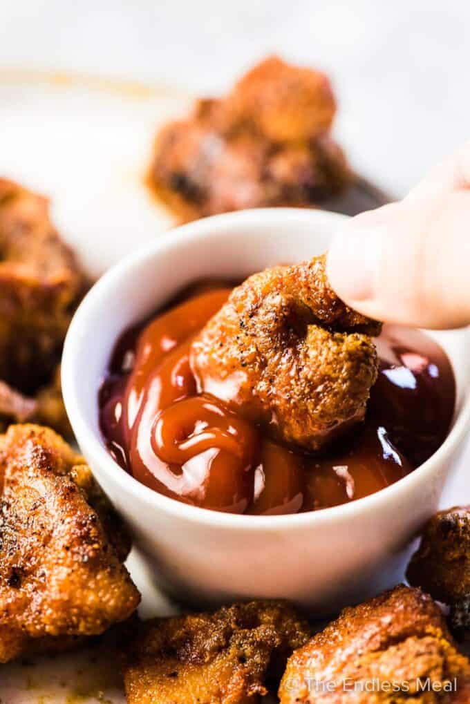 Easy chicken bites being dipped into ketchup.