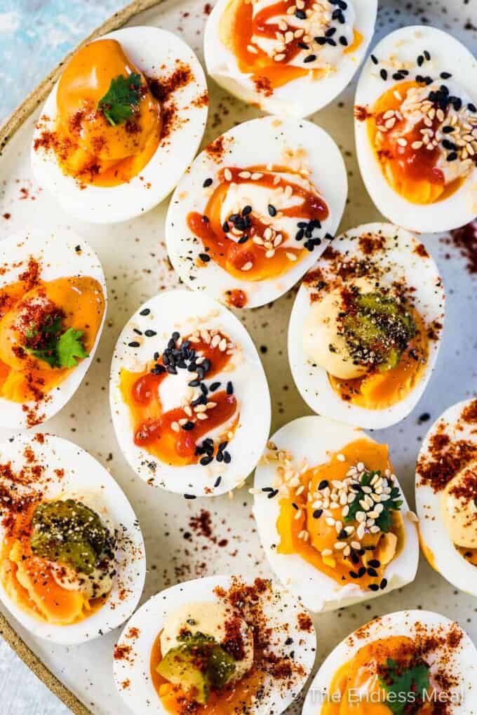 A plate of easy deviled eggs made three different ways.