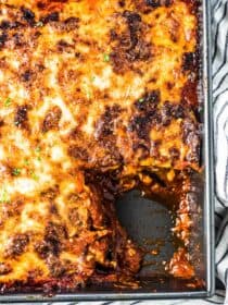 A pan of this easy eggplant parmesan recipe with one scoop taken out.