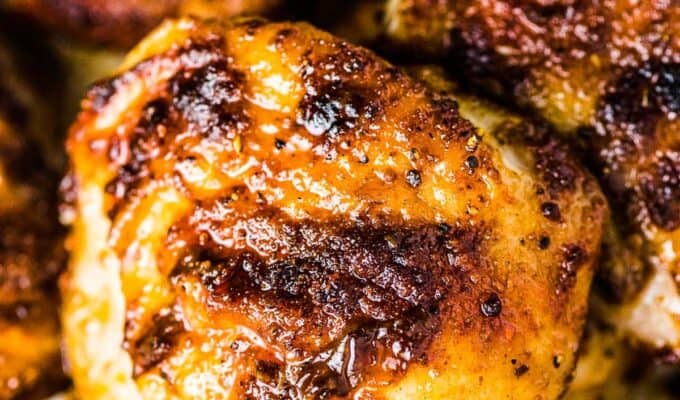 A close up of a stack of juicy baked chicken thighs.