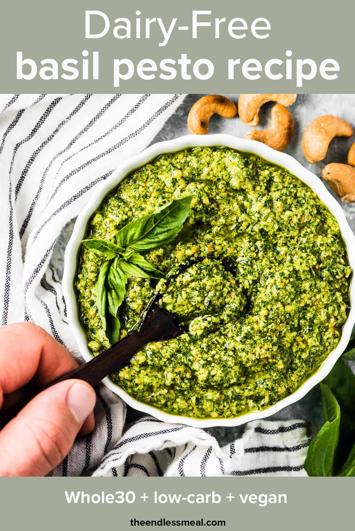 A hand holding a spoon taking a scoop of dairy free pesto with the recipe title on top of the picture. 