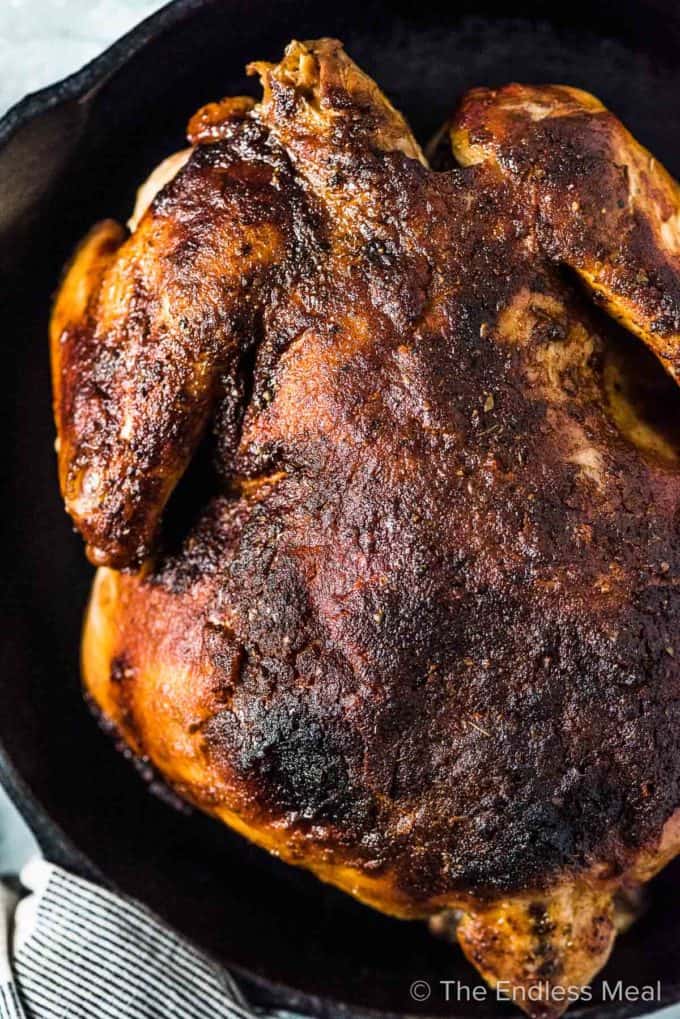 A close up of slow cooker roast chicken with crispy skin.