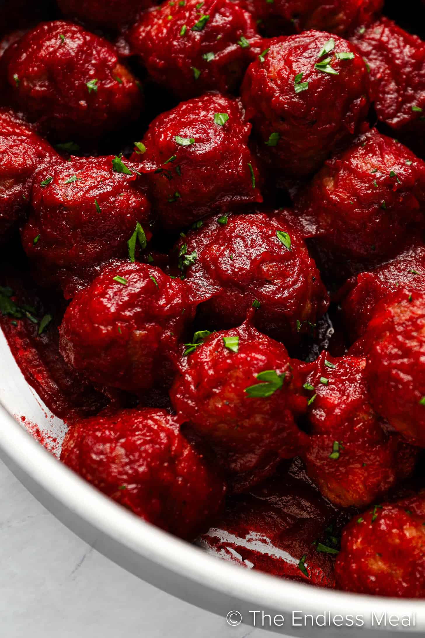 A close up of Cranberry Meatballs in a pan.
