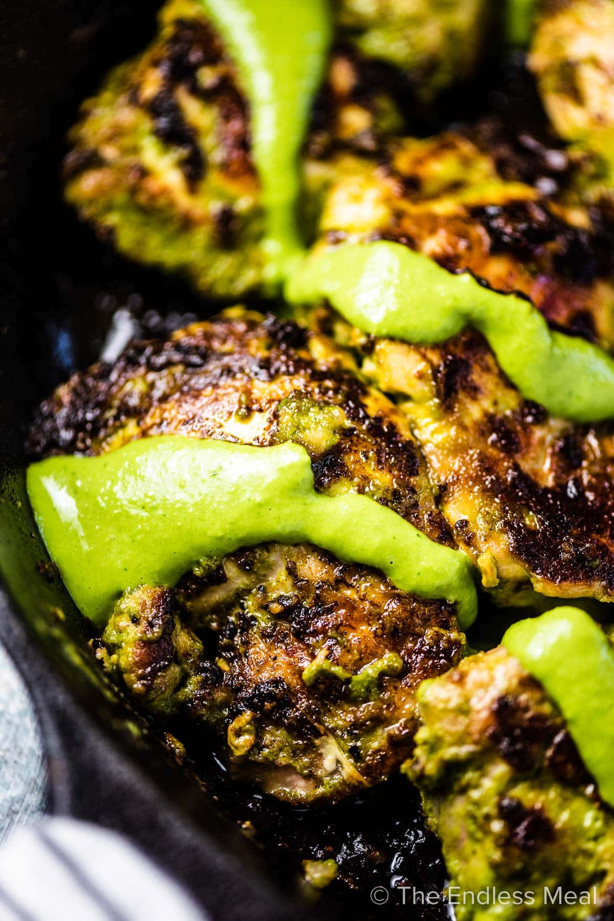 A close up of green goddess chicken in a pan,