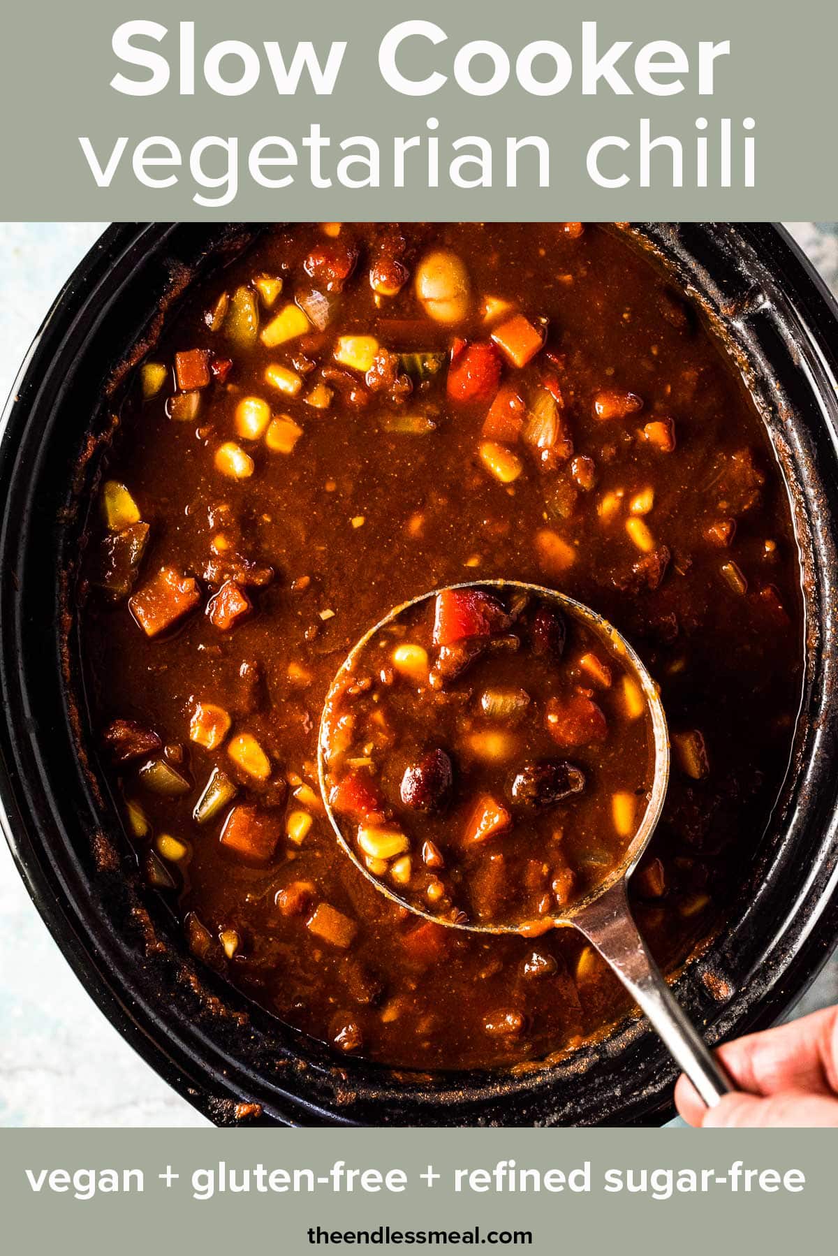 Looking down on vegetarian chili in a slow cooker with a ladle taking a scoop and the recipe title on top of the picture.