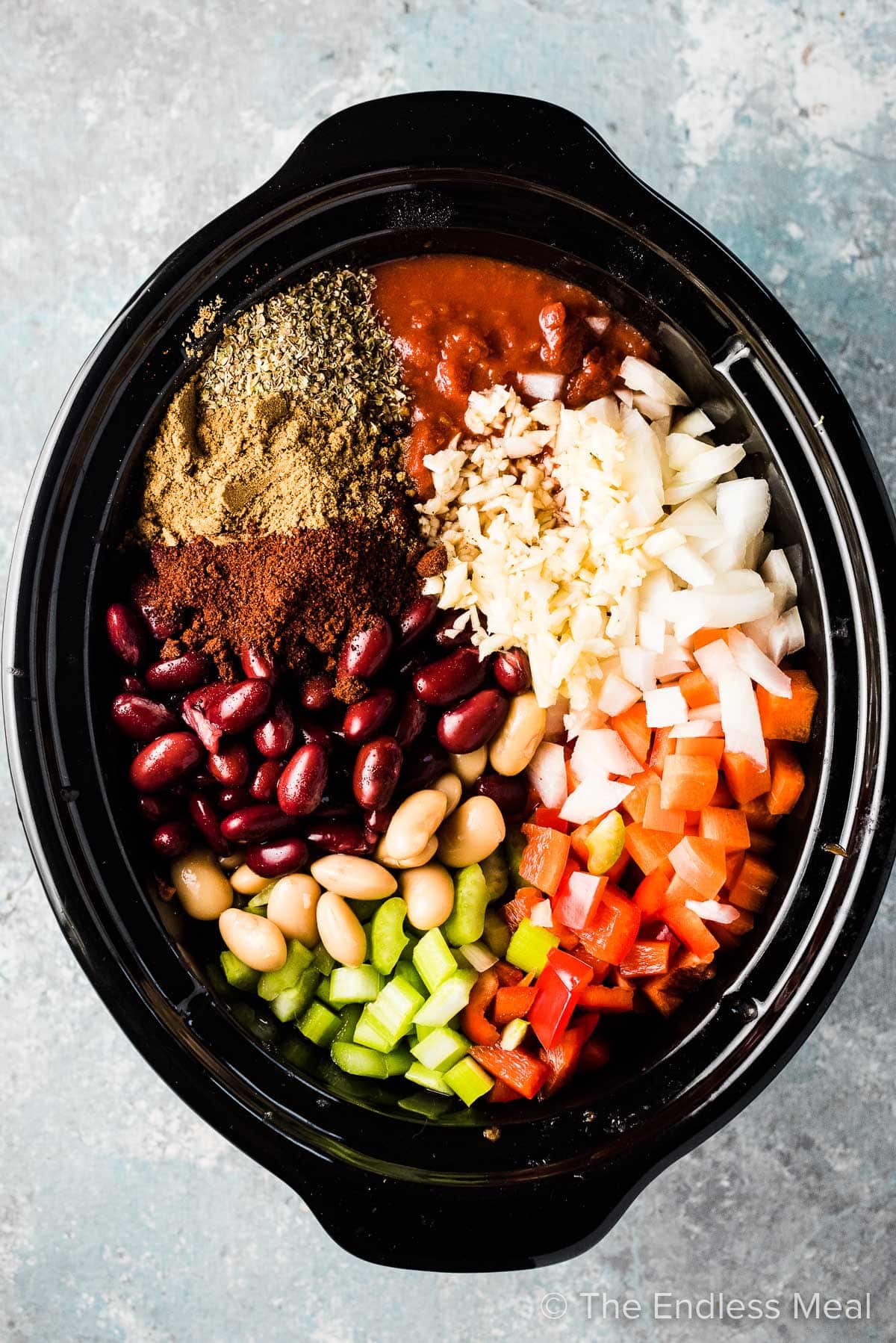 All the ingredients for this vegetarian chili in a slow cooker.
