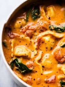 A bowl of healthier creamy tortellini soup with spinach.