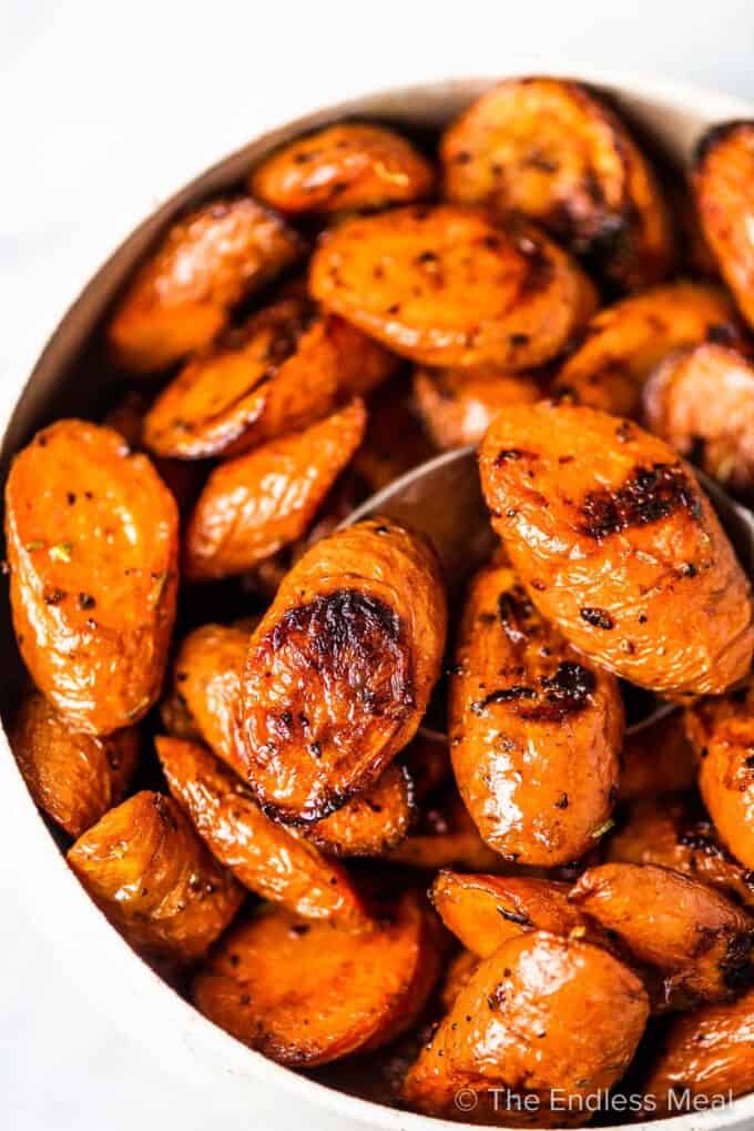 A white bowl filled with easy garlic roasted carrots.