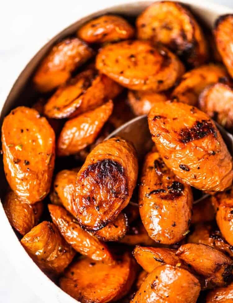 A white bowl filled with easy garlic roasted carrots.