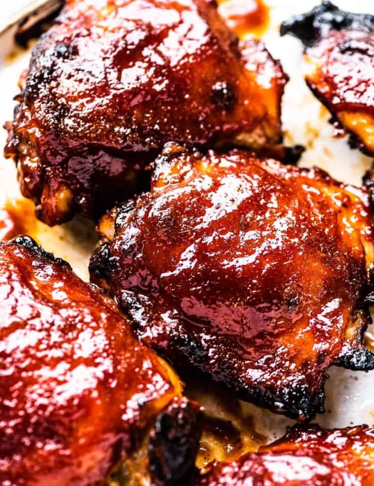 Baked BBQ chicken on a baking sheet.
