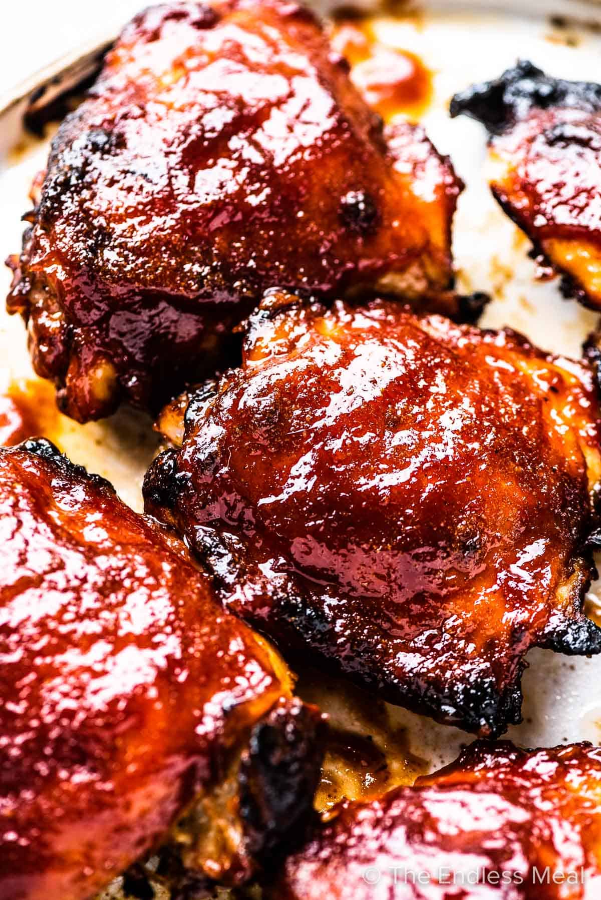Baked BBQ chicken on a baking sheet. 