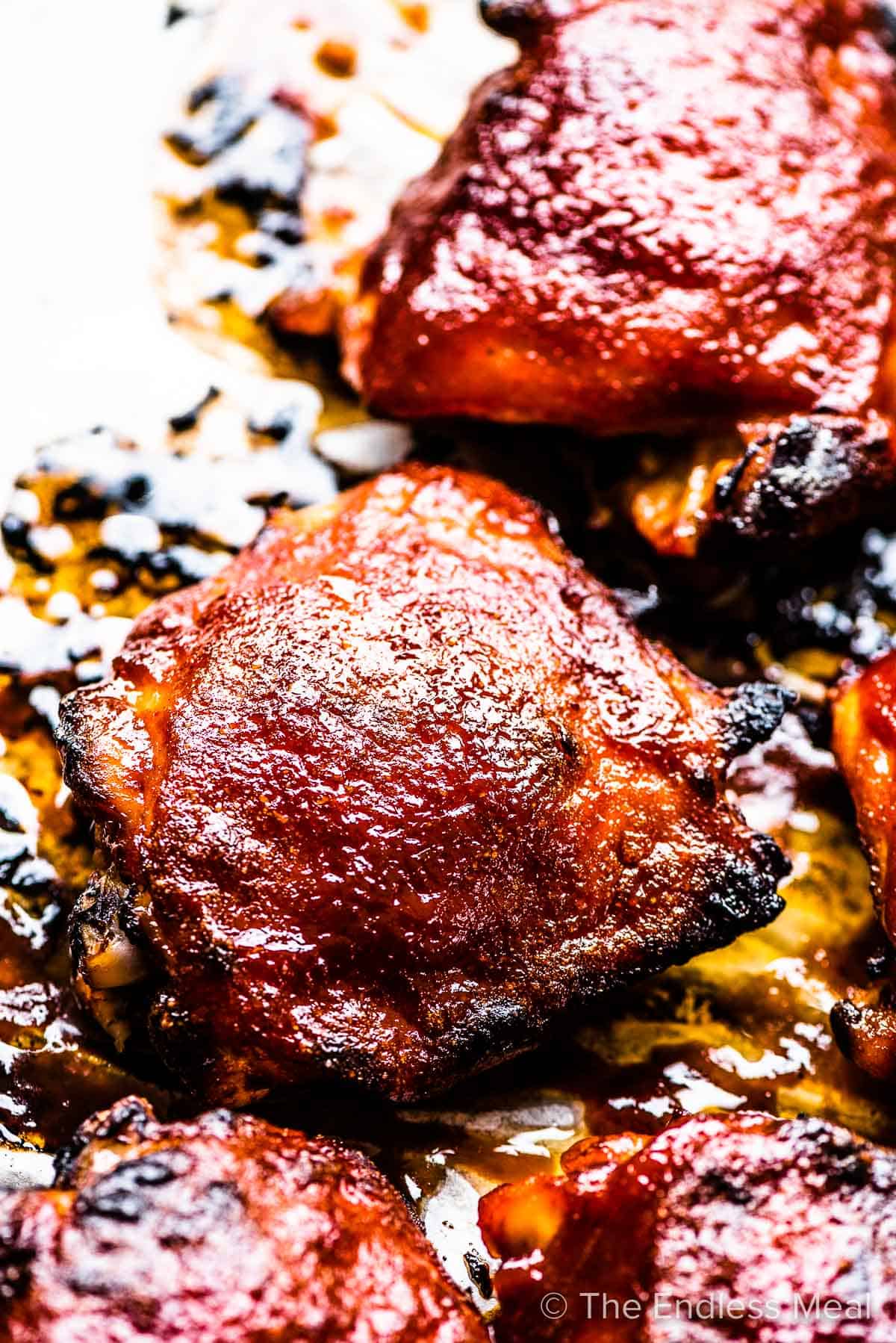 A close up of the bbq chicken on a baking sheet.