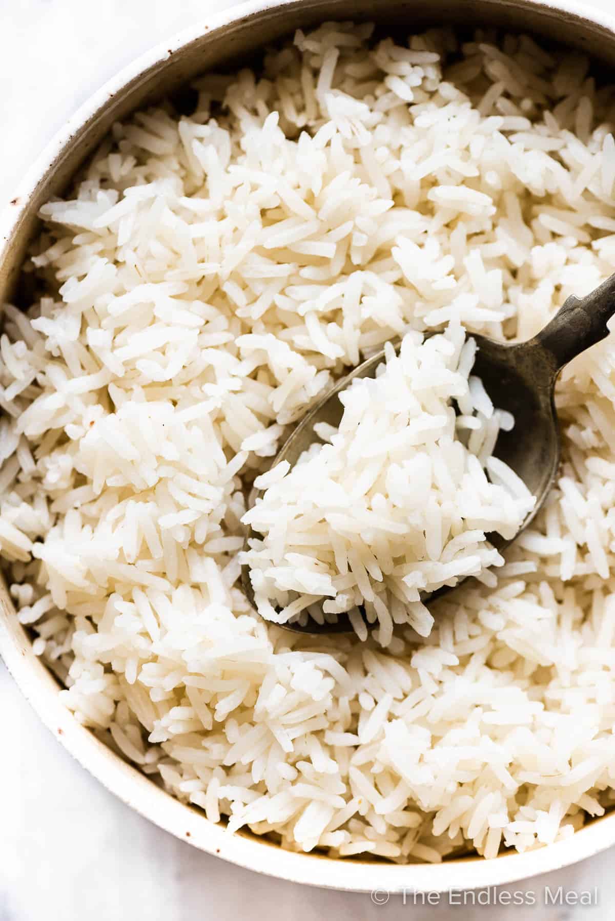Fluffy basmati rice in a bowl with a spoon.