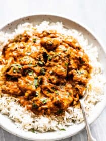 Chicken tikka masala on rice with a fork.