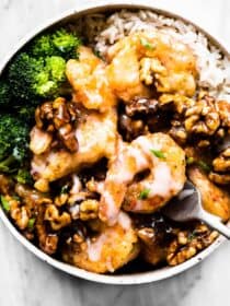 Honey walnut shrimp in a bowl with rice and broccoli.