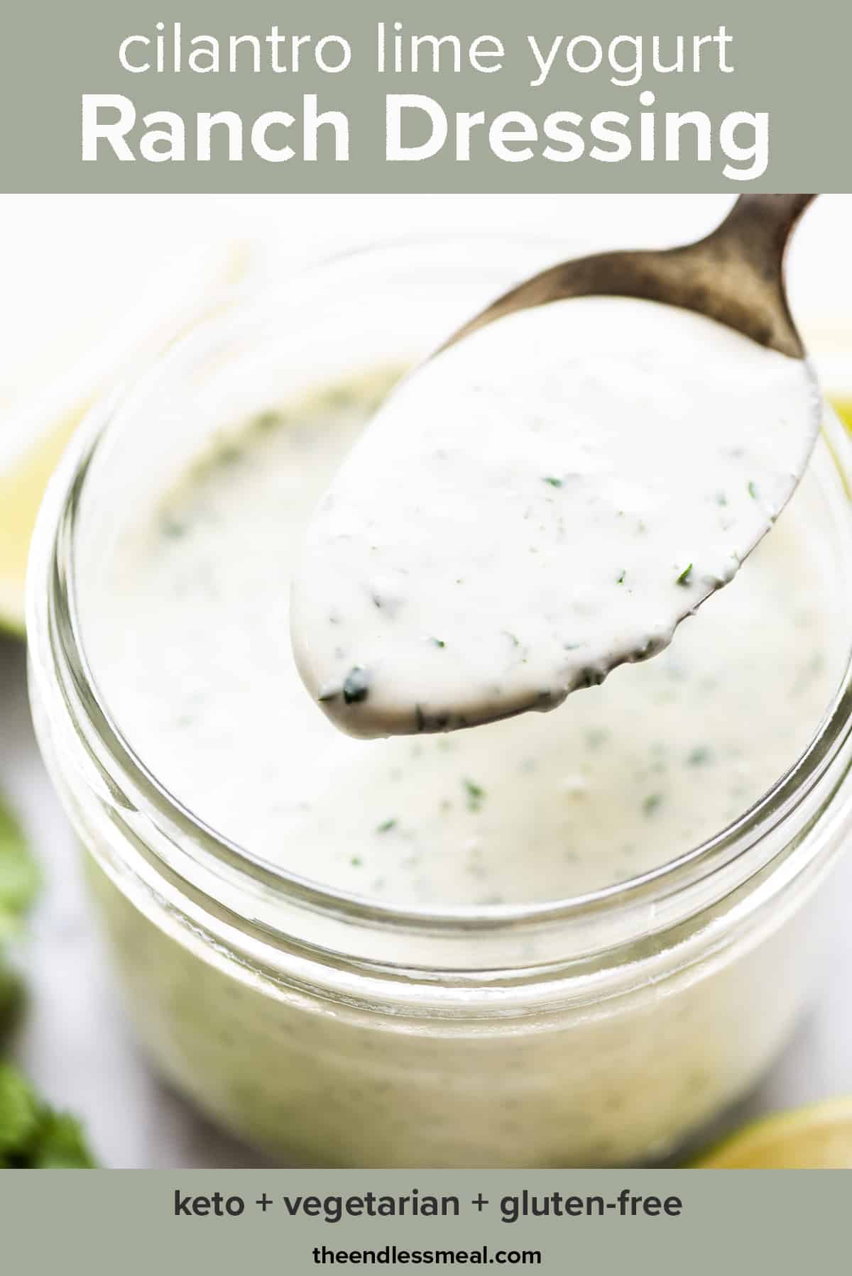 A spoon taking a scoop of cilantro lime ranch dressing out of a glass jar with the recipe title on top of the picture.