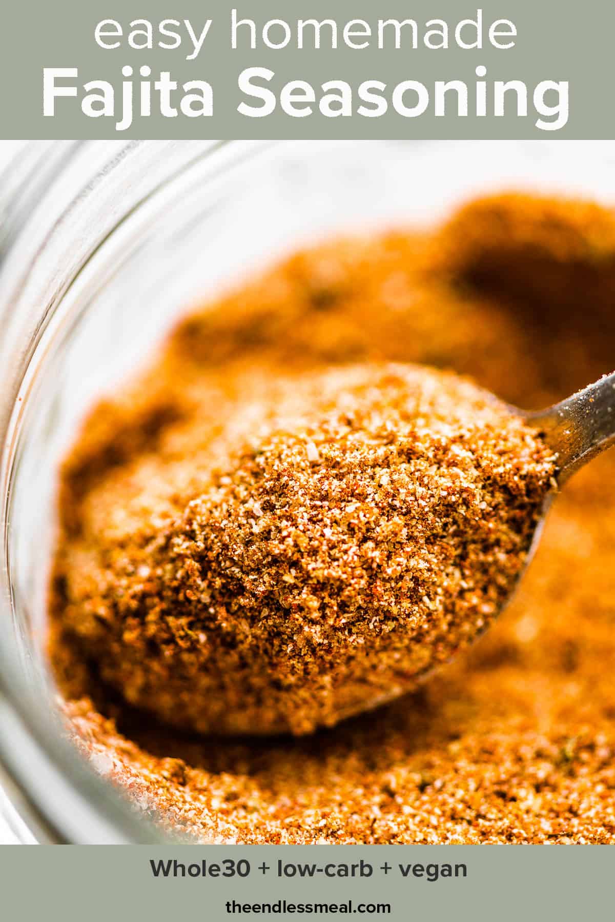 A closeup of a jar of fajita seasoning with a spoon inside with the recipe title on top of the picture.