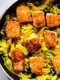 A pan with crispy salmon and cabbage.