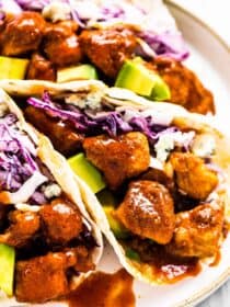 Buffalo chicken tacos on a white plate.