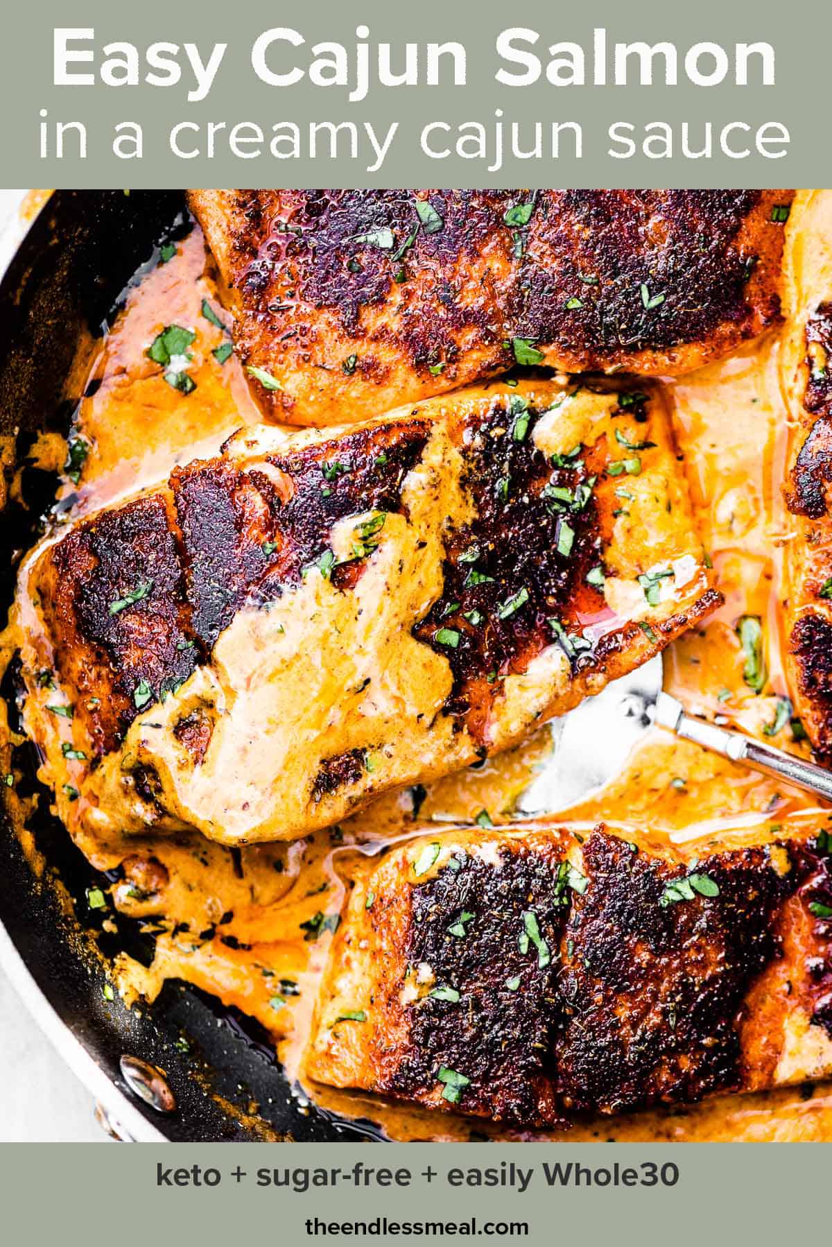 Cajun salmon in a pan with creamy cajun sauce poured over the top and the recipe title on top of the picture.