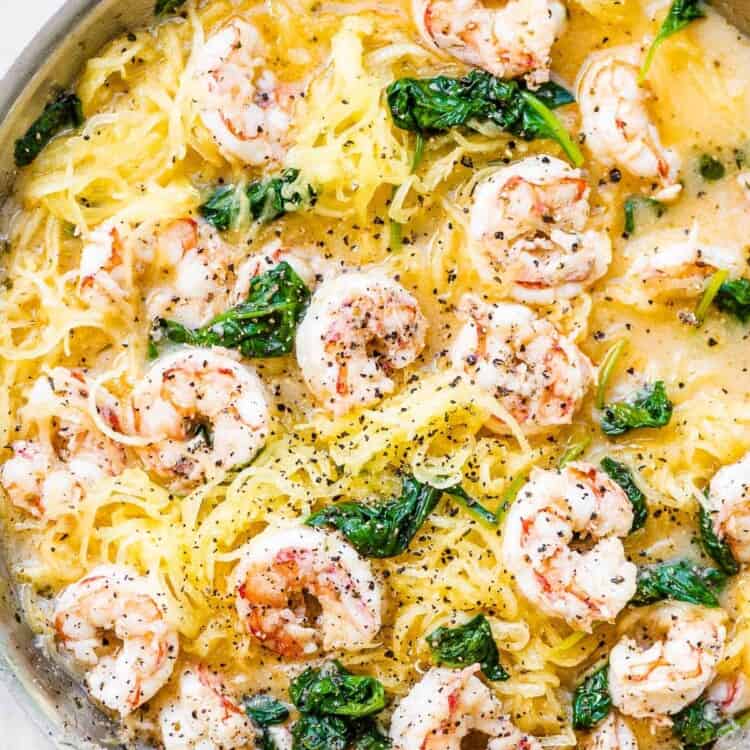 Spaghetti squash shrimp scampi in a pan with some spinach.