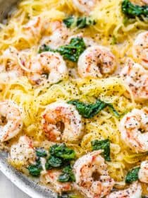 A close up of spaghetti squash shrimp scampi in a pan.