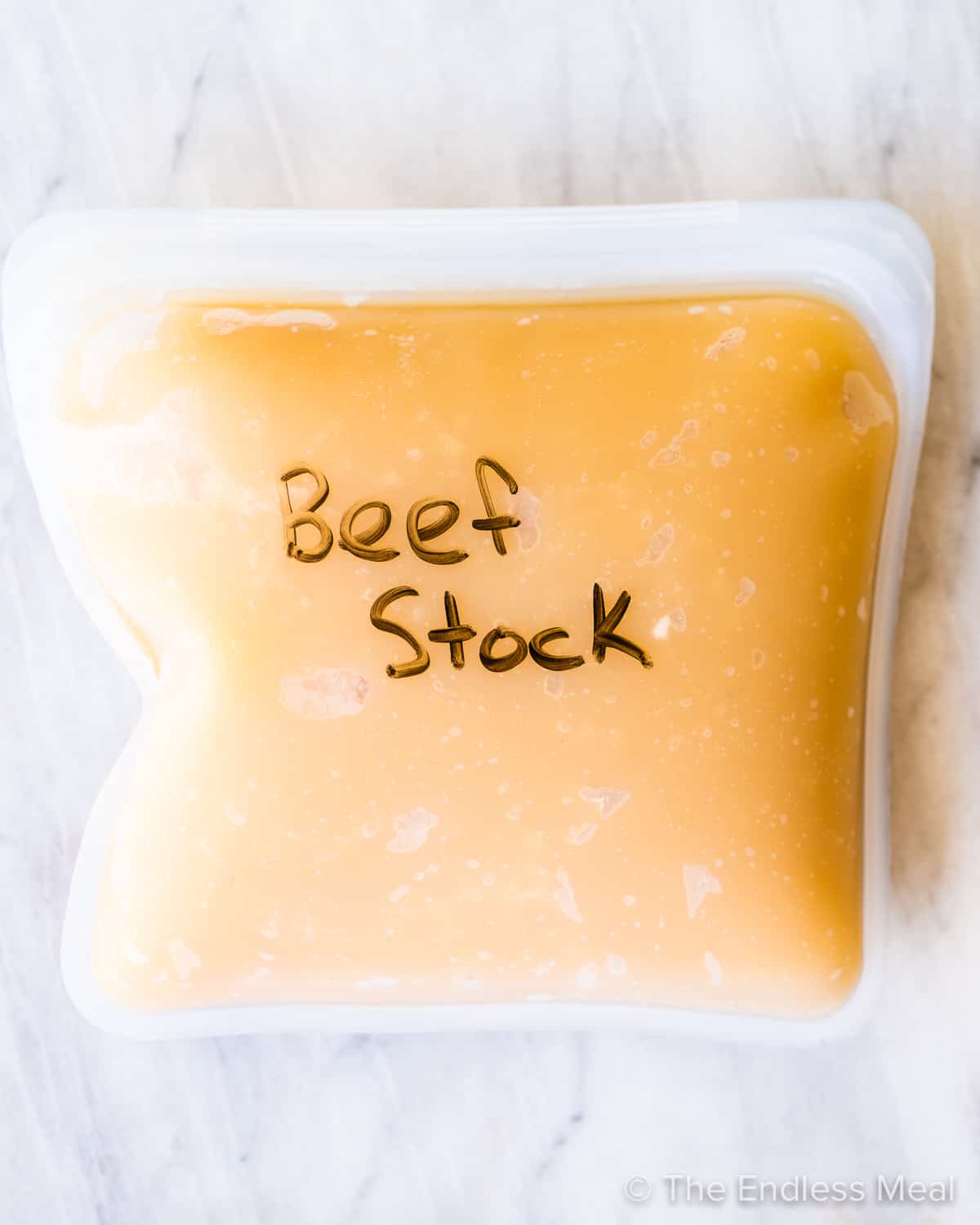A reusable freezer bag filled with beef stock.