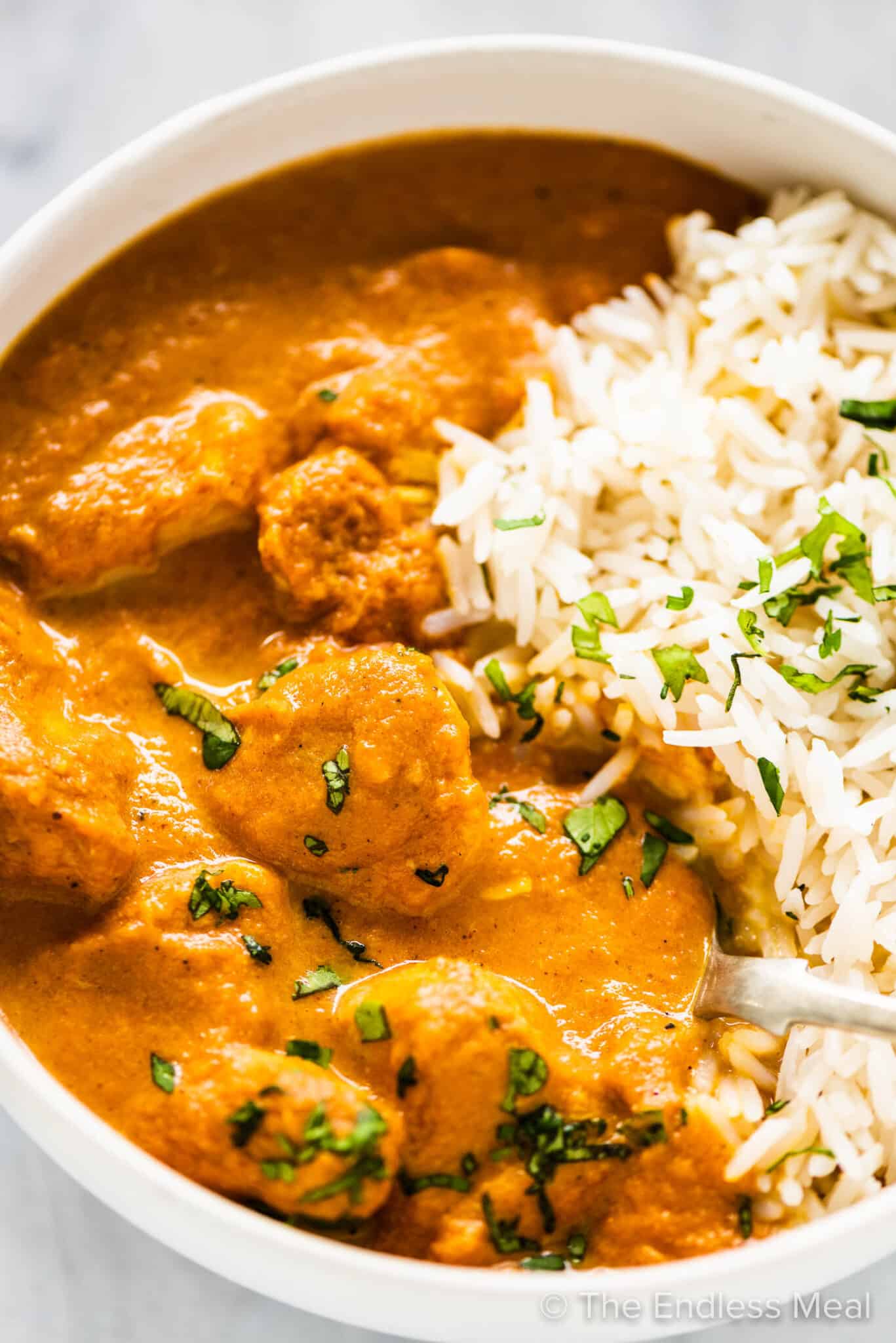 A bowl of crockpot butter chicken and rice.