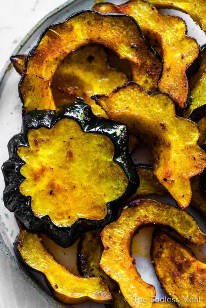 Roasted acorn squash on a serving plate.