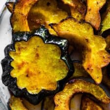 Roasted acorn squash on a serving plate.
