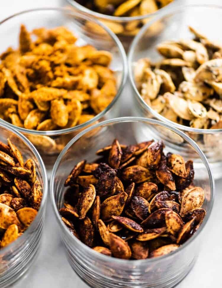 Flavored roasted pumpkin seeds in little dishes.