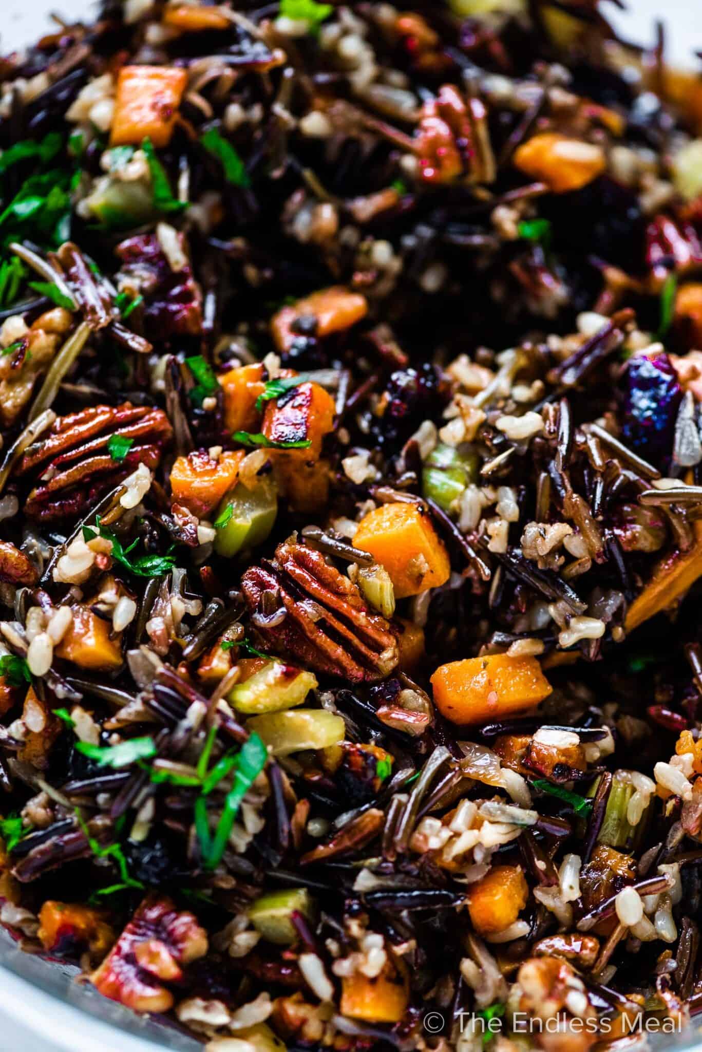 A closeup of wild rice stuffing in a bowl.