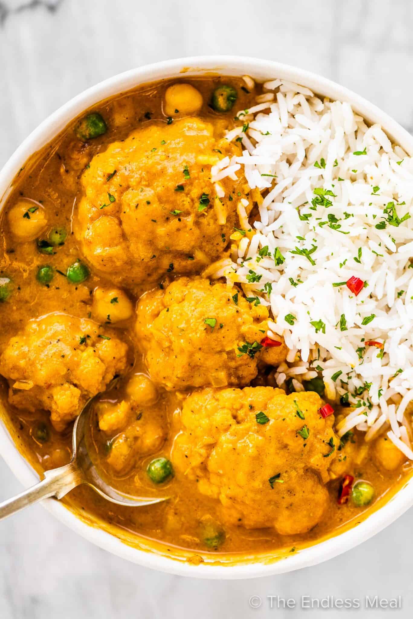A bowl of cauliflower curry and rice. 
