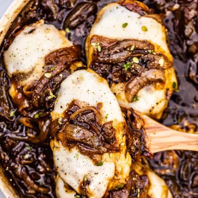 French onion chicken in a pan with melted cheese.