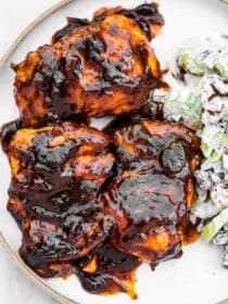 Stovetop BBQ chicken on a plate with celery salad.