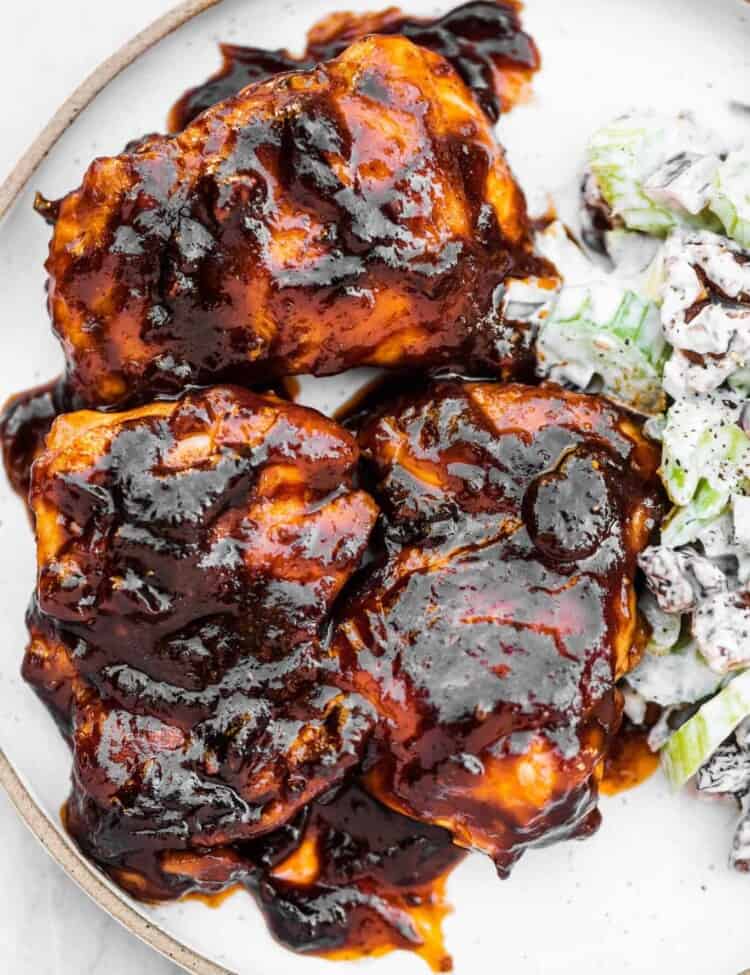 Stovetop BBQ chicken on a plate with celery salad.