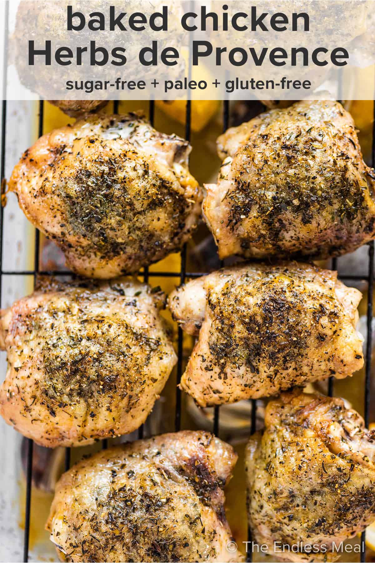 Herbs de Provence Chicken on a baking sheet with the recipe title on top of the picture.