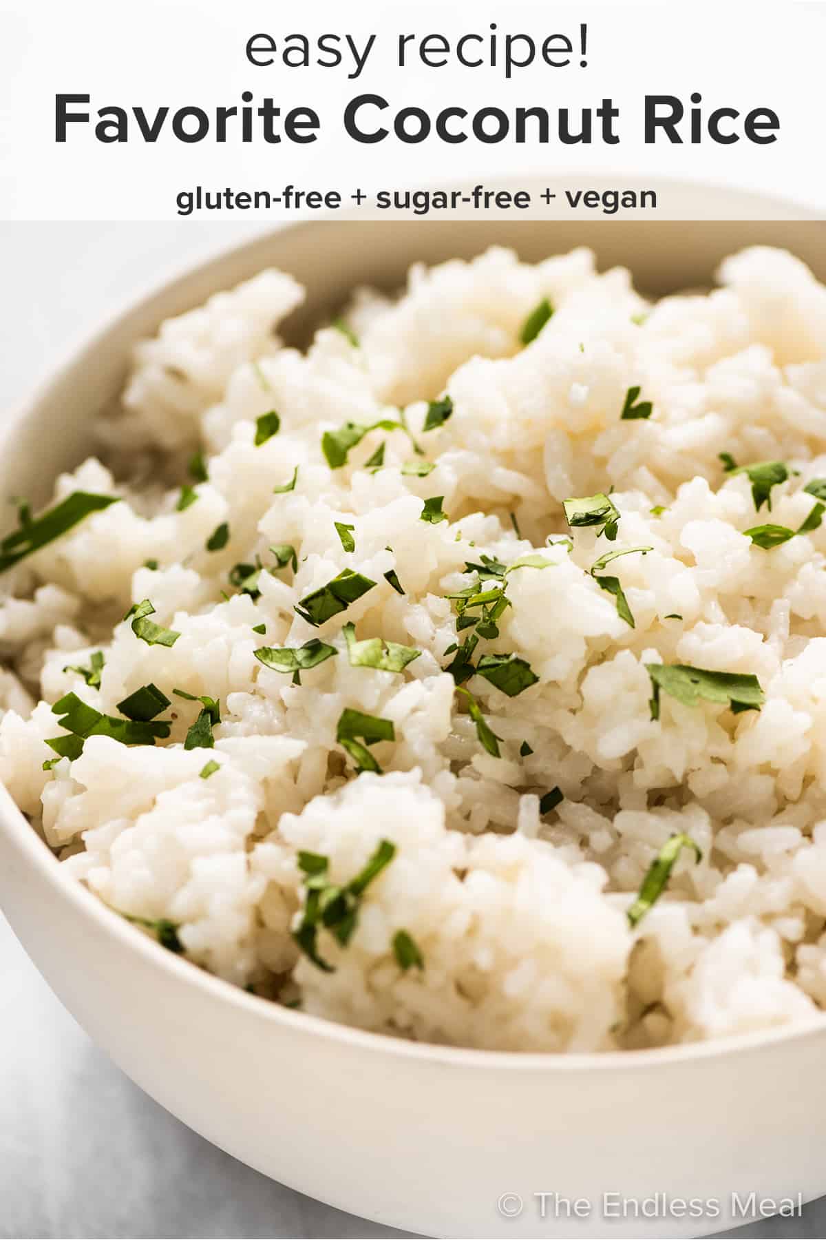 Coconut rice in a white bowl with the recipe title on top of the picture. 