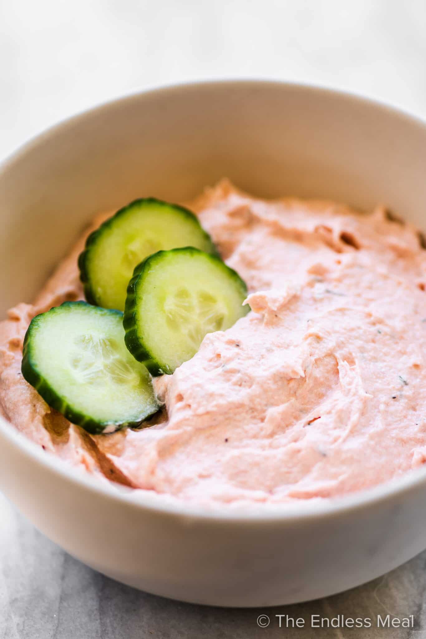 Salmon mousse served as a dip in a bowl.