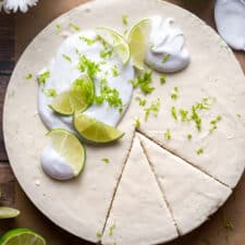 Healthy Key Lime Pie cut into slices with whipped cream on top.