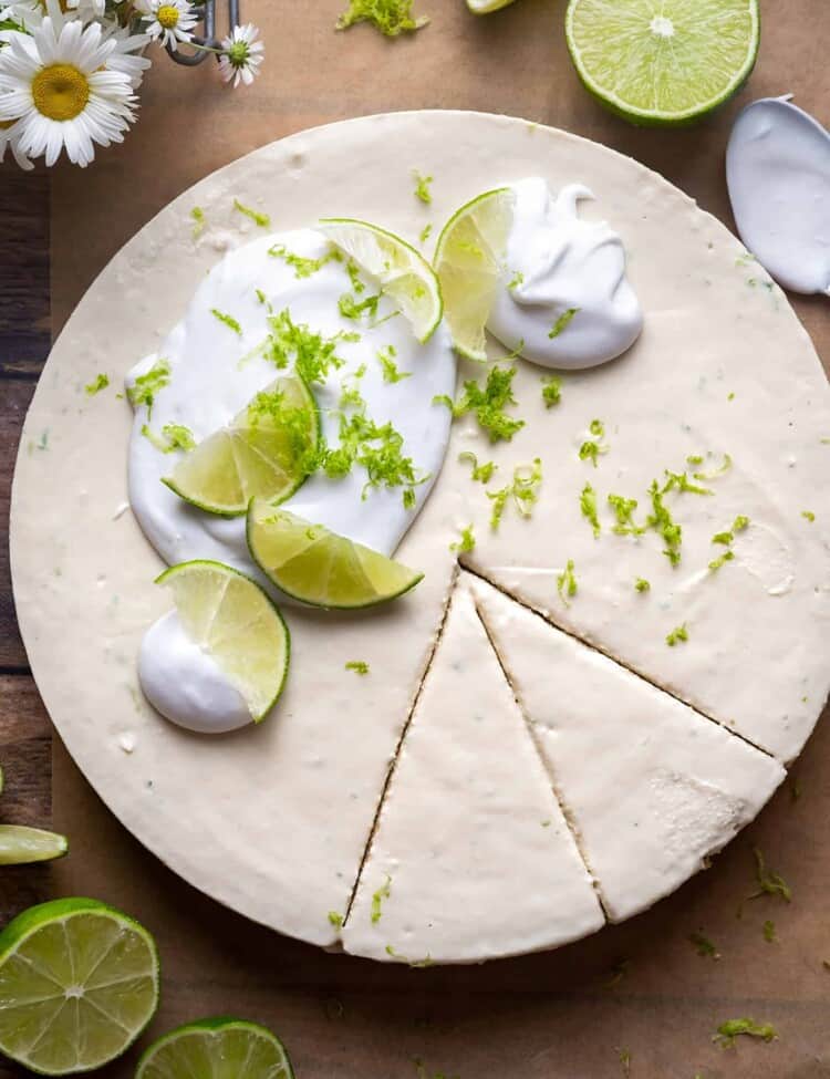 Healthy Key Lime Pie cut into slices with whipped cream on top.