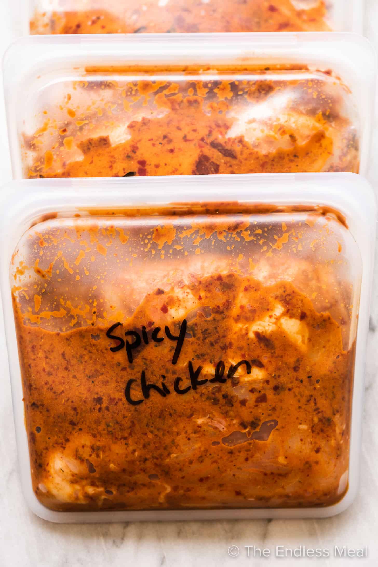 Spicy chicken marinating in freezer bags.
