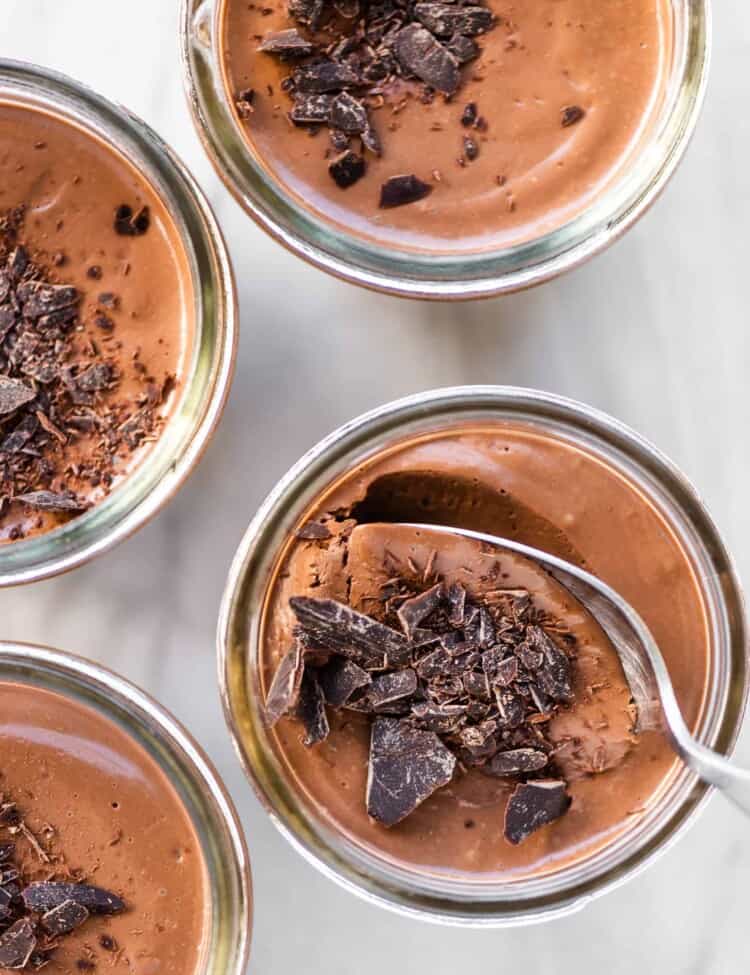 4 vegan pots de creme with chocolate on top.